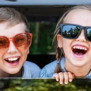 Happy kids looking out the car window