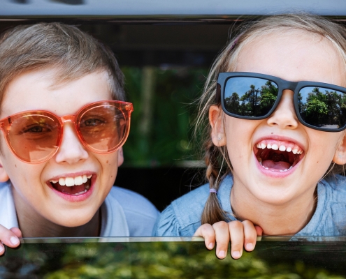 Happy kids looking out the car window