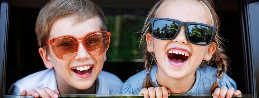 Happy kids looking out the car window