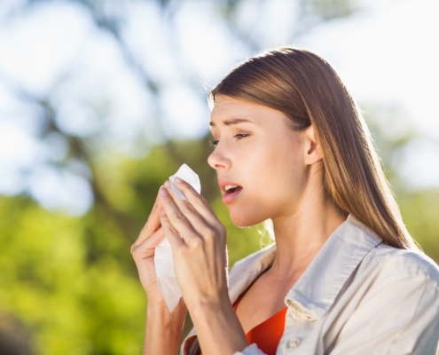 beautiful-woman-using-tissue-while-sneezing