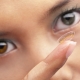 Woman with soft lens on her fingertip