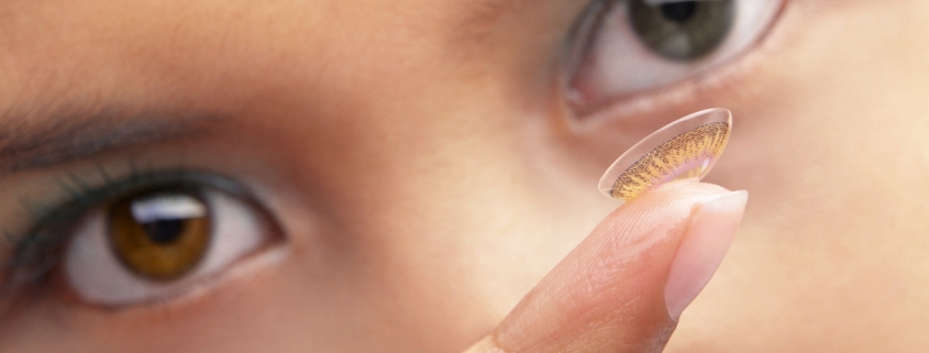 Woman with soft lens on her fingertip